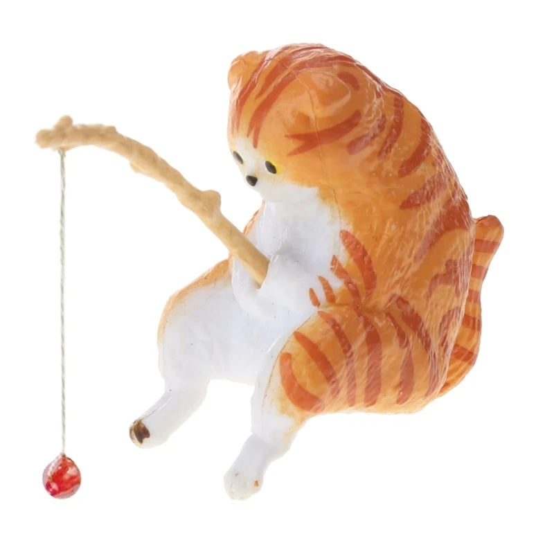 Cat figurine with a fishing rod and fish on a white background