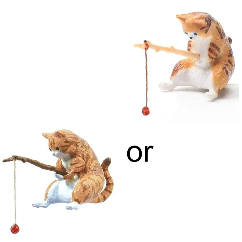 Two cat figurines with fishing rods and a ball on a white background.
