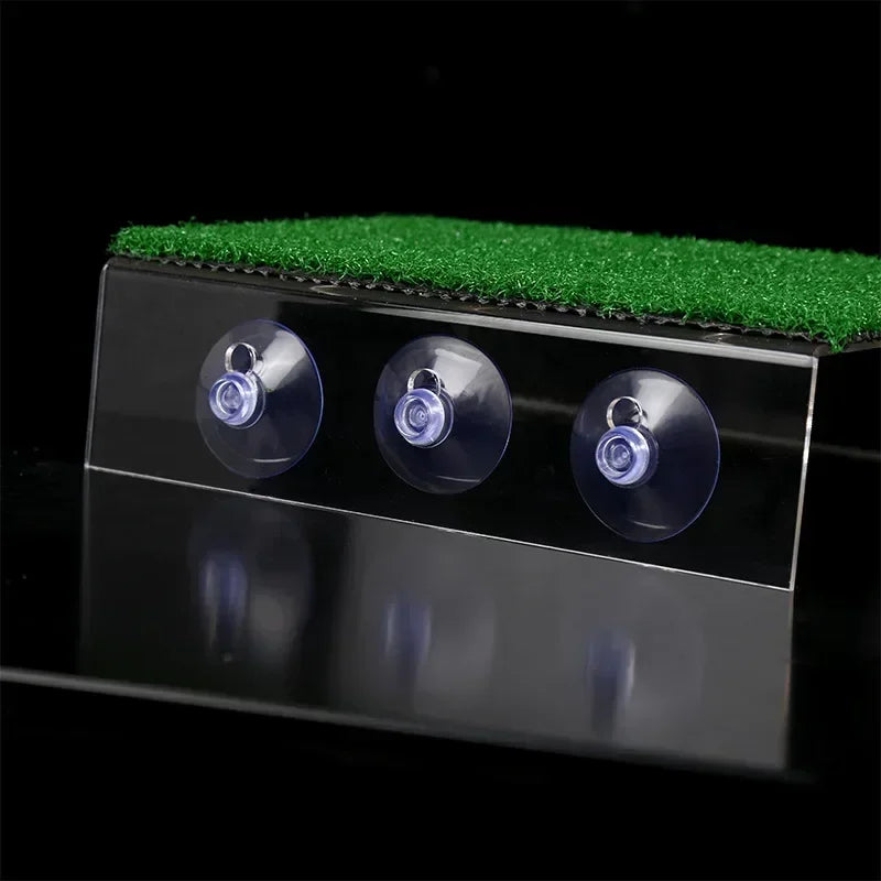 Golf simulator device with grass top and three laser sensors on a reflective surface.