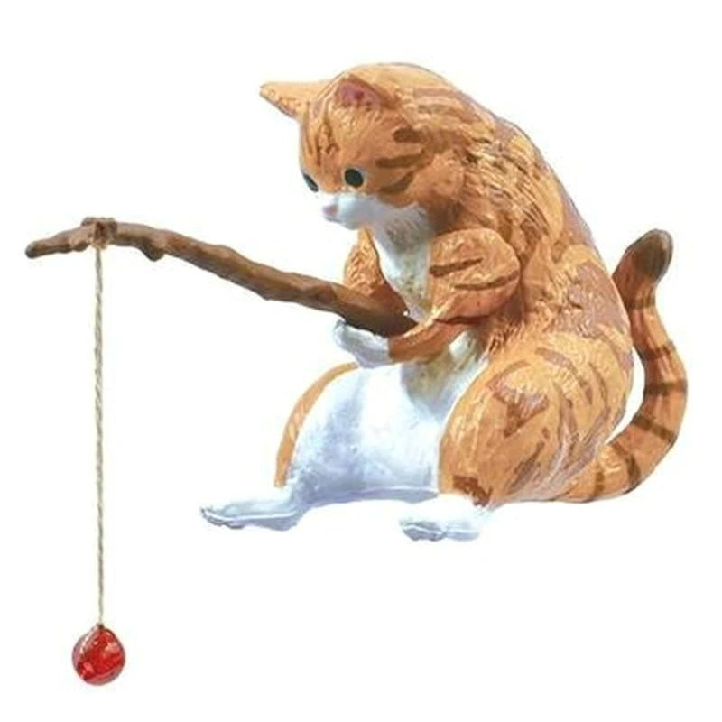 Cat-shaped toy with a dangling red ball on a white background