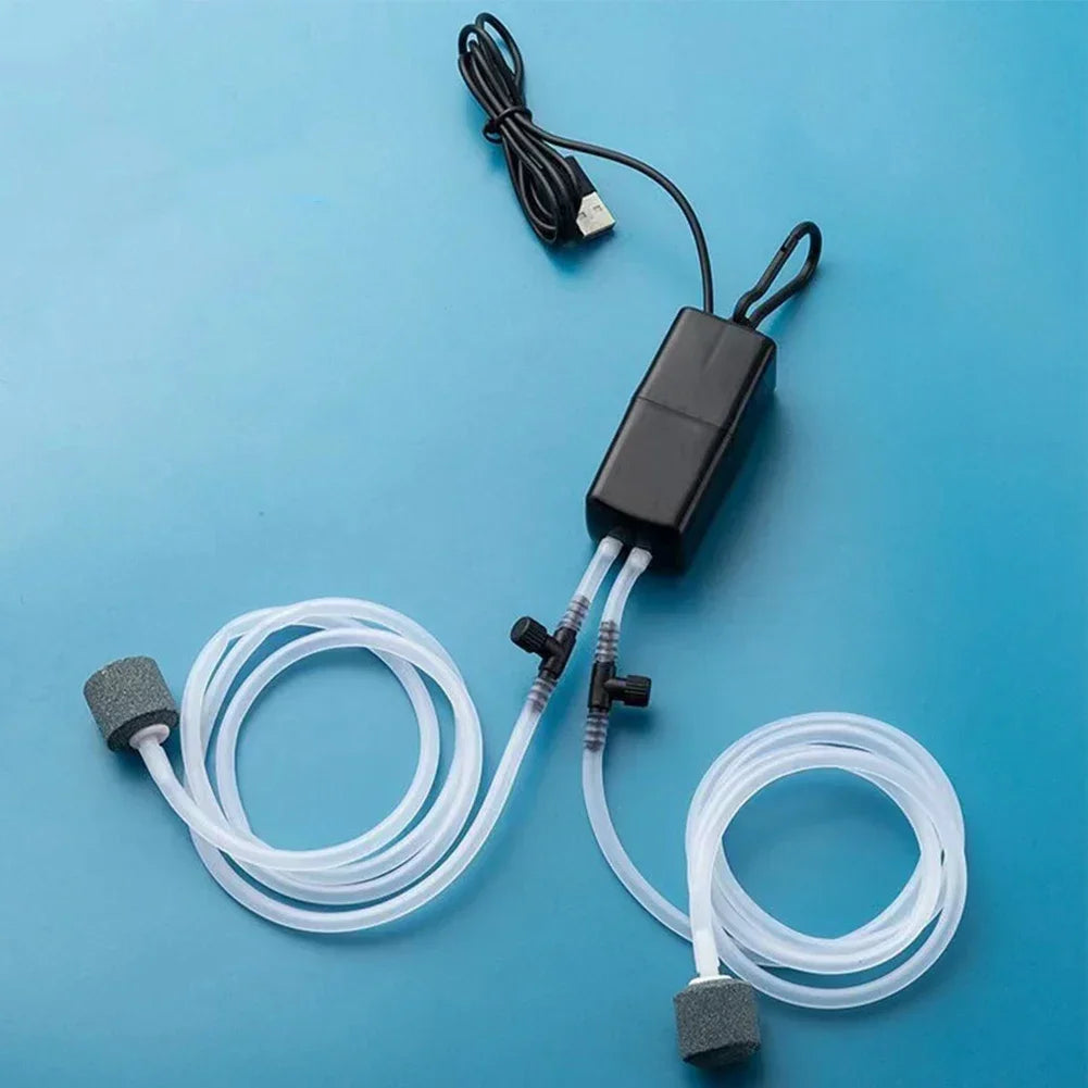 Aquarium air pump with hoses on a blue background