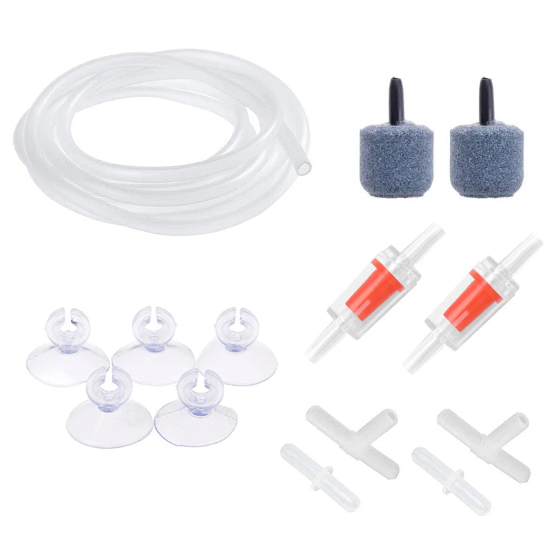 Set of aquarium accessories including tubing, filters, and suction cups on a white background