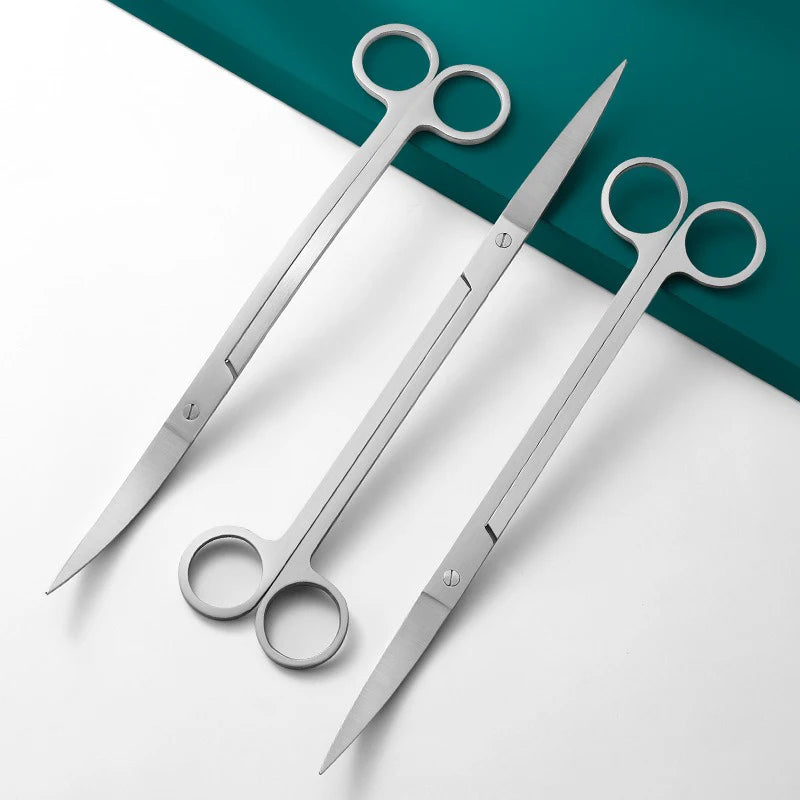Set of surgical scissors on a white and teal background