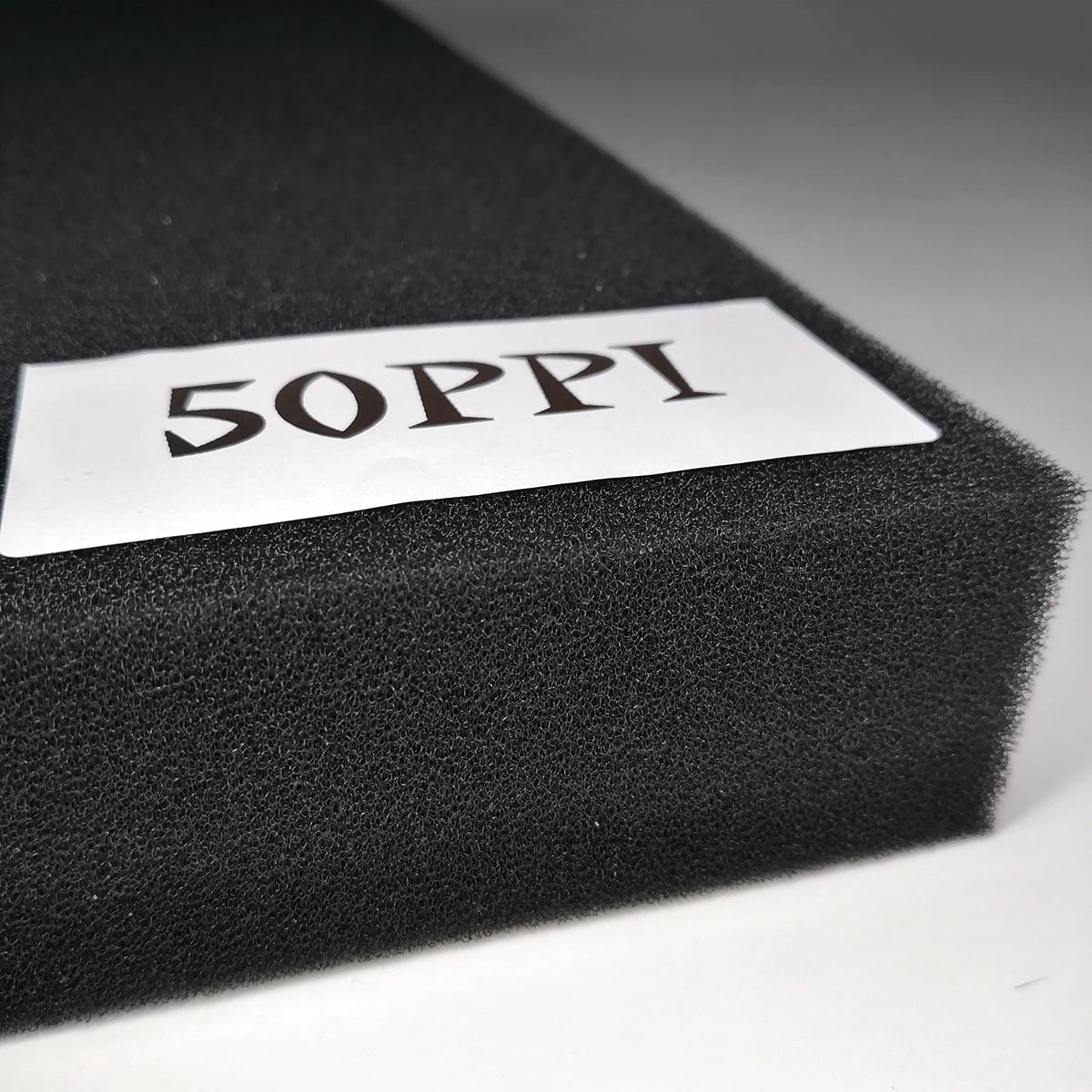 Black foam block with '5OPPI' label on a gray background