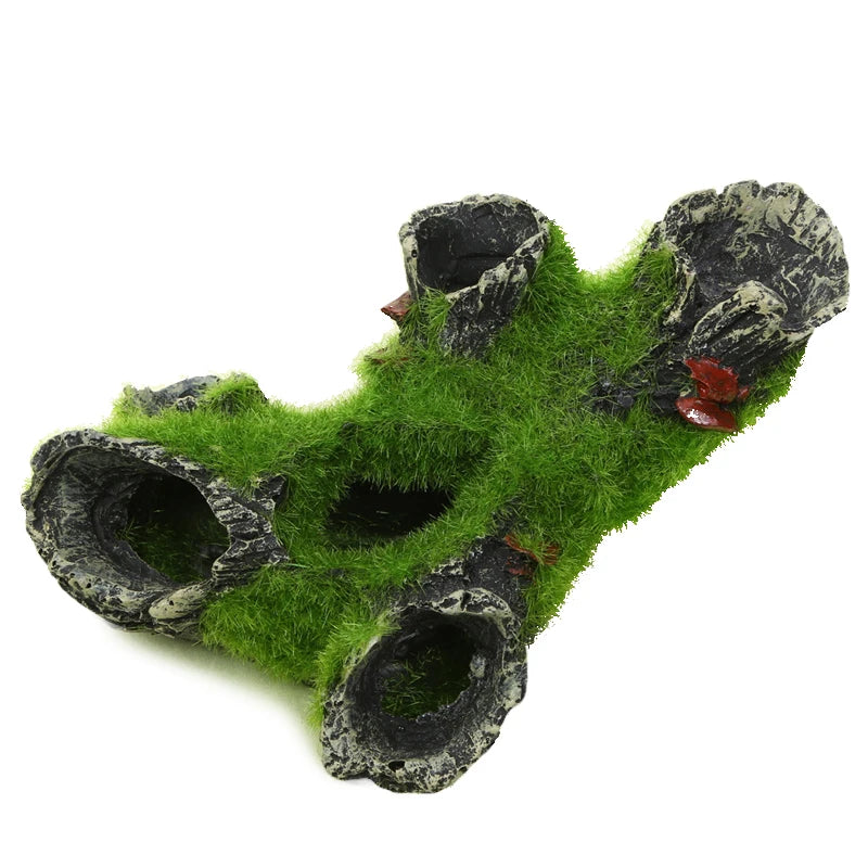 Decorative aquarium rock structure with green moss on a white background