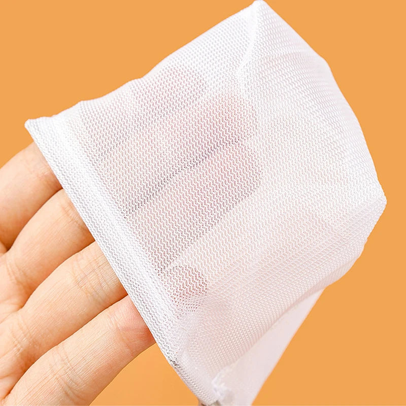 White cloth held by a hand against an orange background