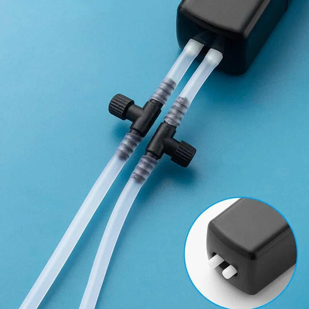 Black aquarium pump with clear tubes on a blue background