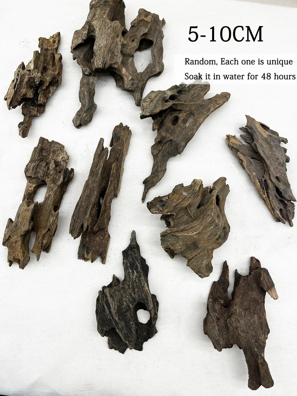 Decorative driftwood pieces on a white background with text indicating size range and soaking instructions.