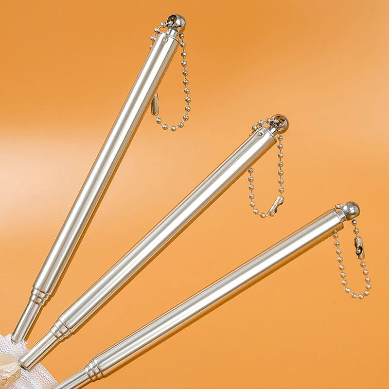 Three silver metal sticks with chains on an orange background