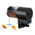 Black automatic fish feeder with fish and water on a white background
