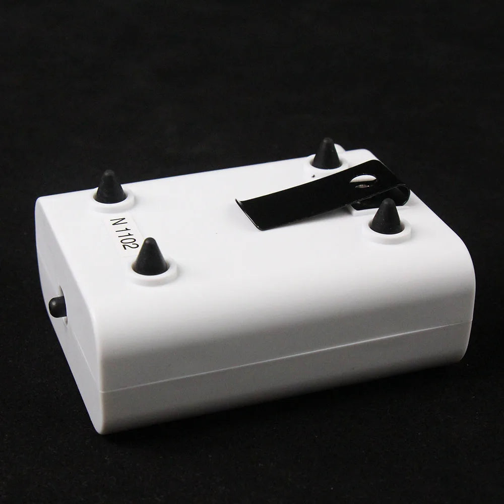 White electronic device with black components on a black background