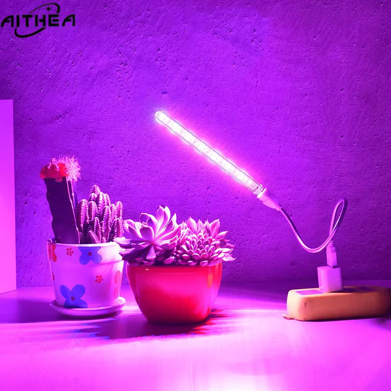 LED grow light illuminating potted plants against a purple background with 'AITHEA' branding.