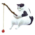 Cat toy resembling a cat playing with a branch and red ball on a white background