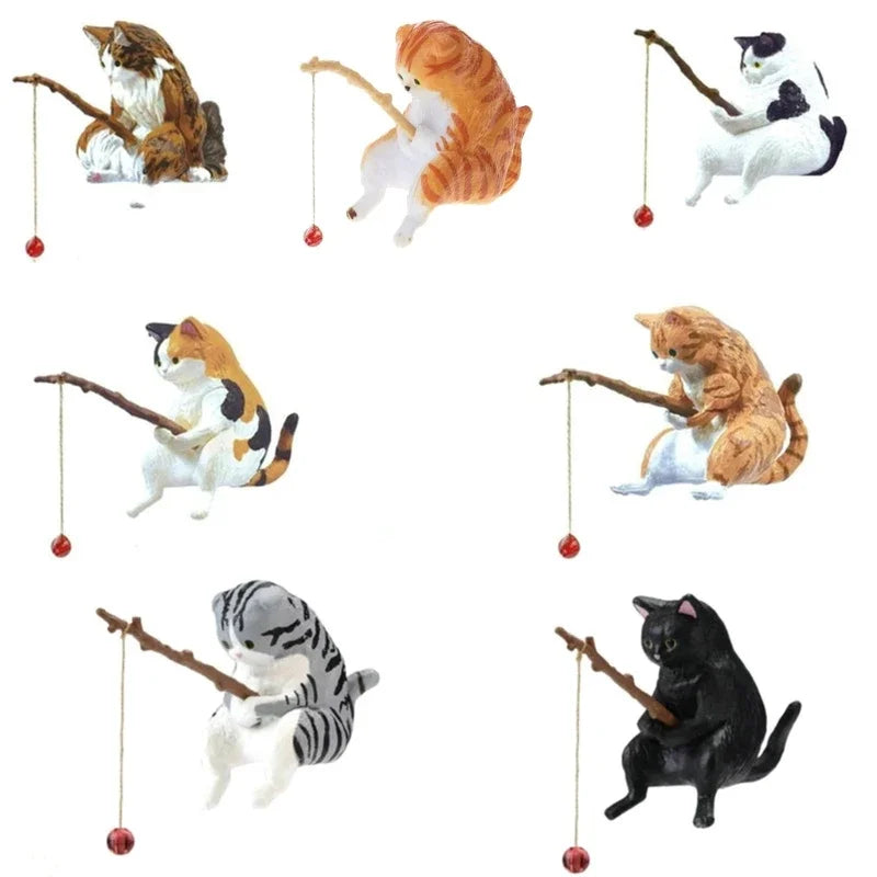 Set of cat figurines playing with fishing rods on a white background