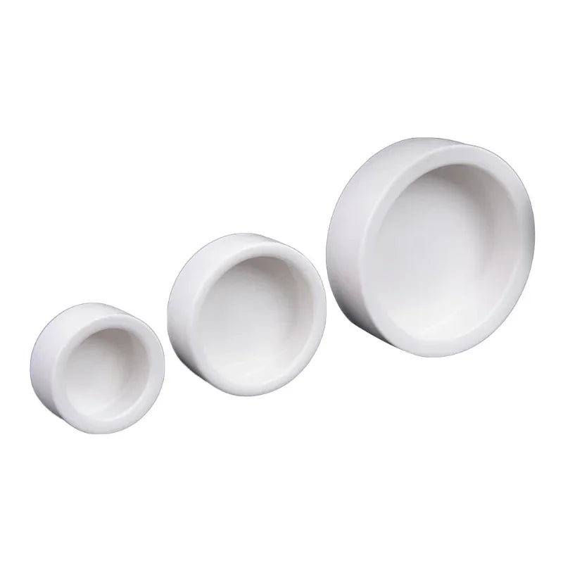 Three white ceramic bowls of different sizes on a white background
