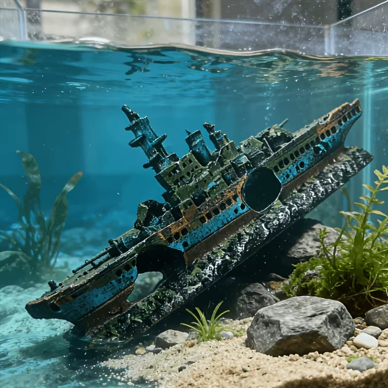 Model of a sunken ship in an aquarium with water and plants.